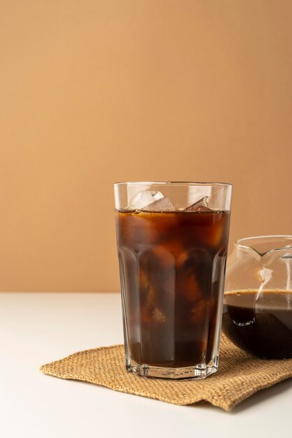 Glass with iced coffee on table