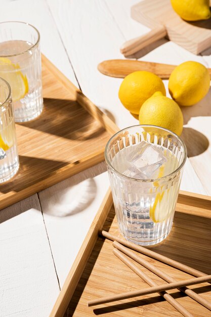 Glass with lemon drink on table