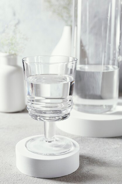 Glass with water on table