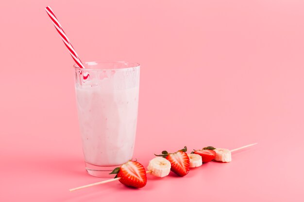 Glass of yogurt with fruit skewer