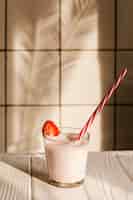 Foto gratuita bicchiere di yogurt sul tavolo di legno
