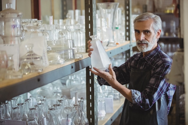 Glassblower examining glassware