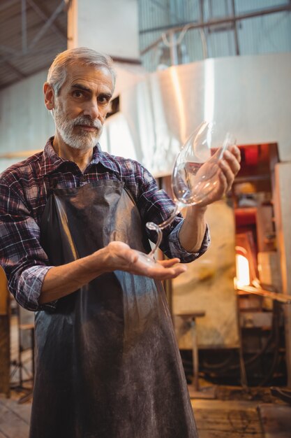 Glassblower holding glassware