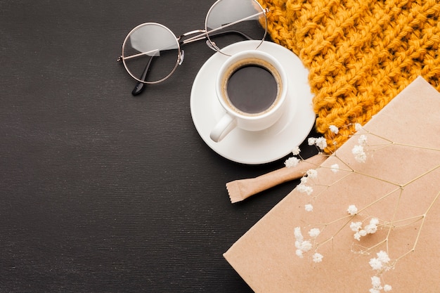 Glasses beside cup of coffee