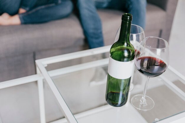 Glasses and bottle of wine on table