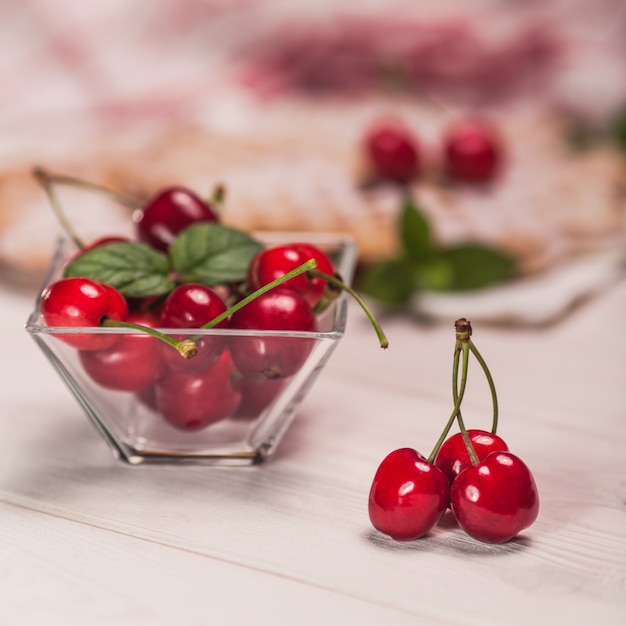 Glasses bowl full of cherries
