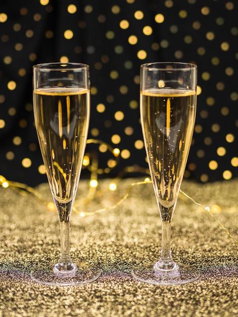 Glasses of champagne on golden textile