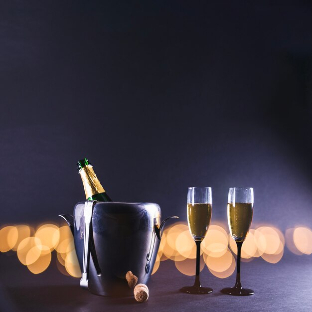 Glasses of champagne with bottle in bucket