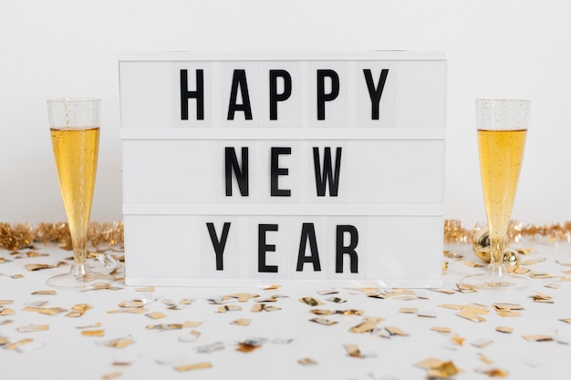 Glasses of champagne with happy new year sign