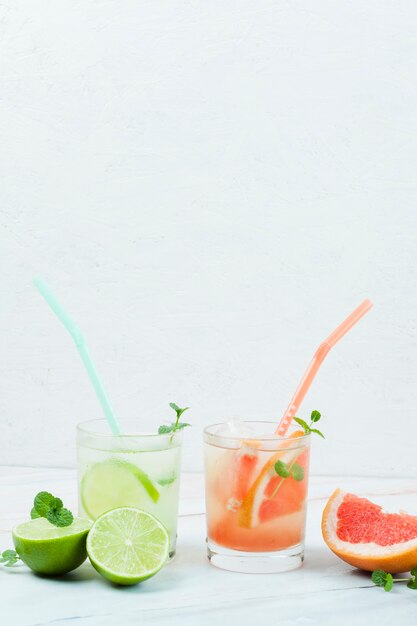 Glasses of cold fruit drink with straws
