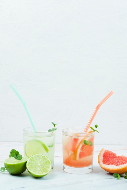 Glasses of cold fruit drink with straws