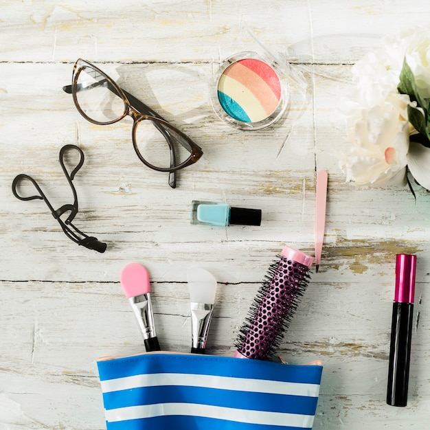 Glasses and cosmetics near makeup bag