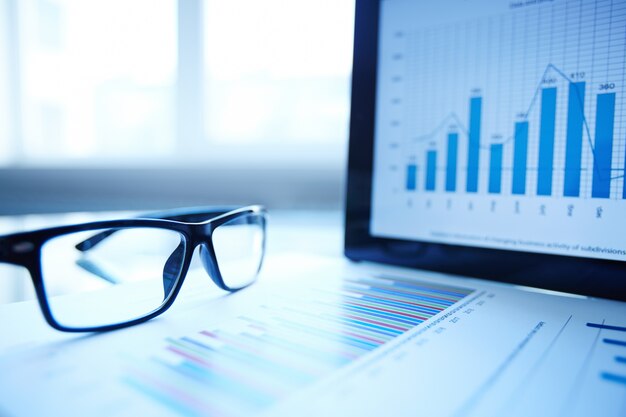 Glasses and digital tablet on desk