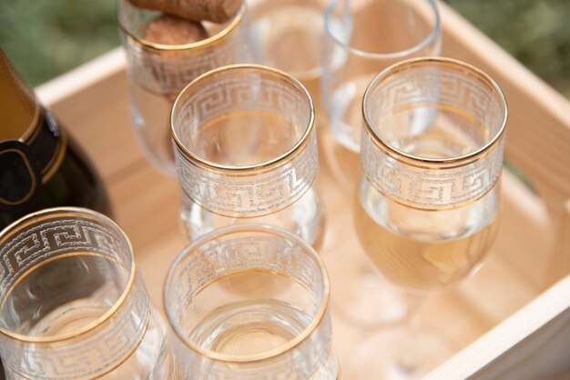 Glasses filled with champagne in wooden crate