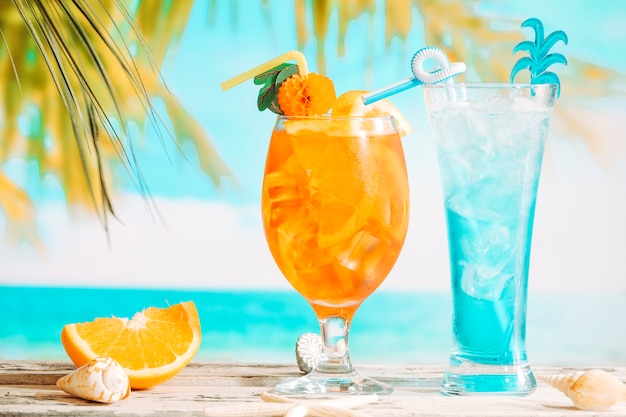 Glasses of fresh drinks decorated with citrus and sliced orange starfish