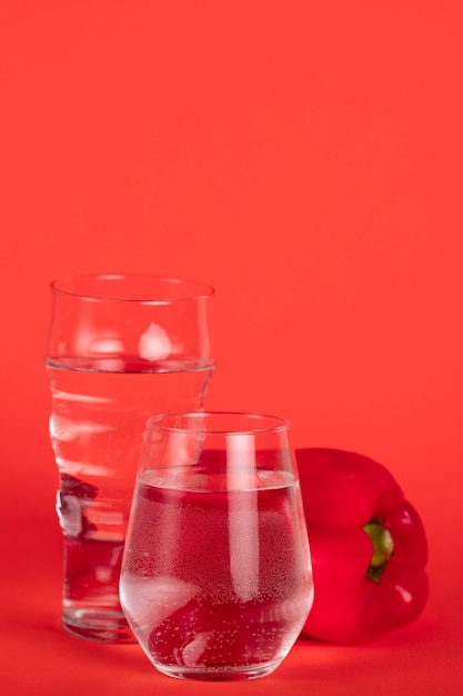Glasses full of water with red pepper
