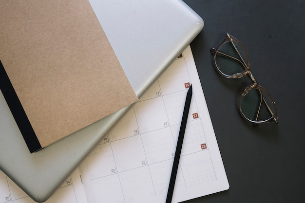 Glasses and laptop near calendar