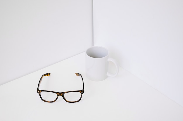 Glasses lying next to mug