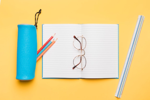 Free photo glasses lying on opened notebook with blank pages