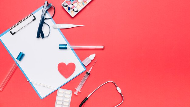 Glasses and medical stuff around clipboard