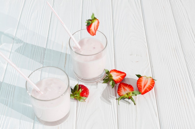 Glasses of milkshake with strawberries