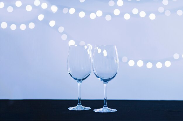 Glasses near abstract lights
