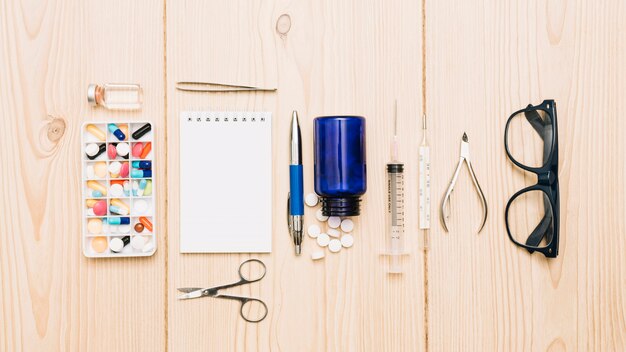 Glasses and notebook near medicines