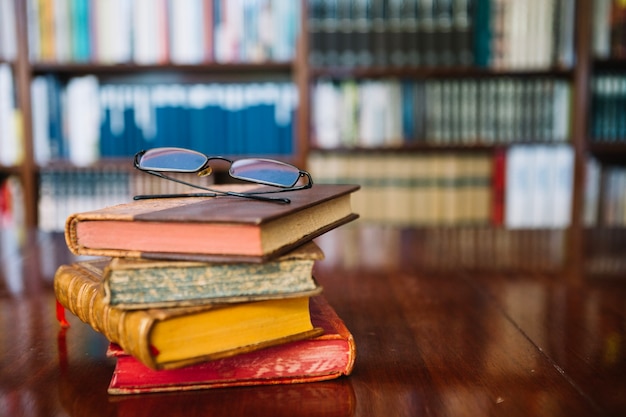 Glasses on old books in library