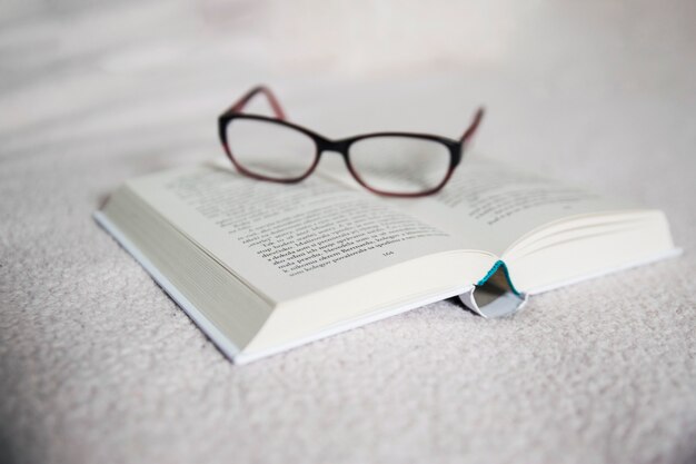 Glasses on opened book