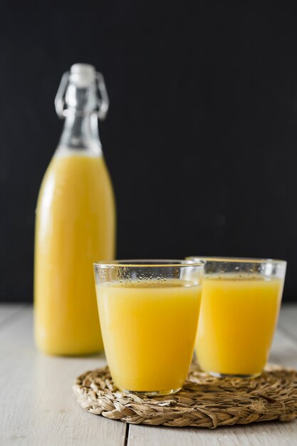 Glasses of orange juice and bottle