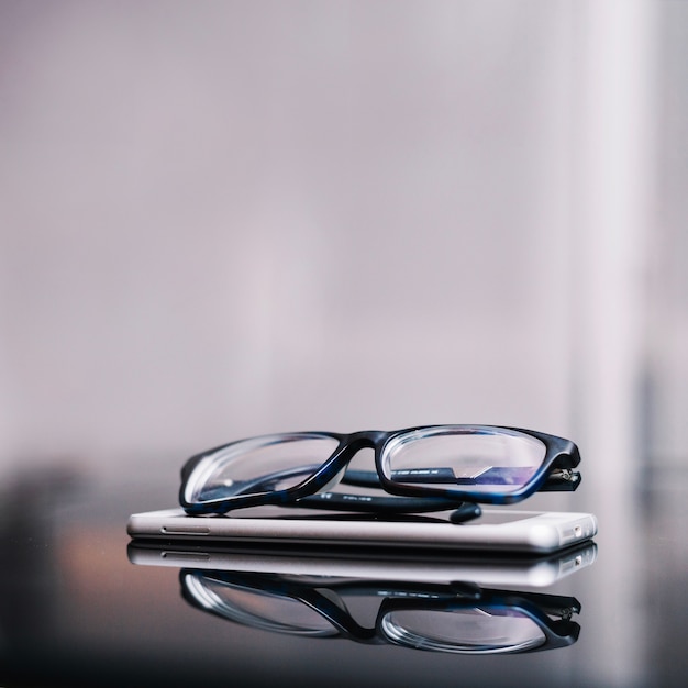 Glasses and phone on table