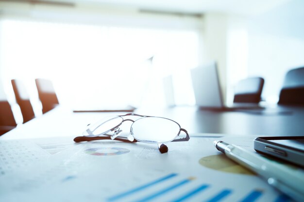 Glasses on table in business meeting room.