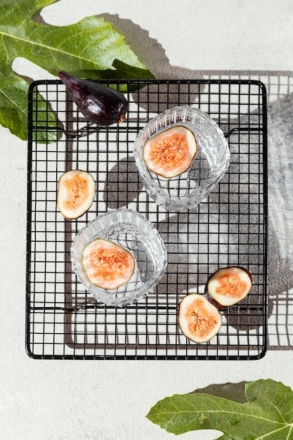 Free photo glasses of water with fruit on table