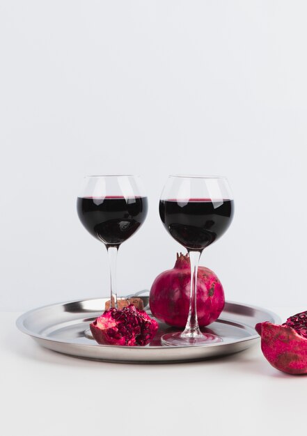 Glasses of wine with pomegranate on a tray