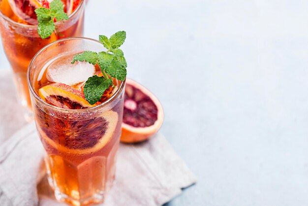 Glasses with aromatic fruit ice tea and copy-space