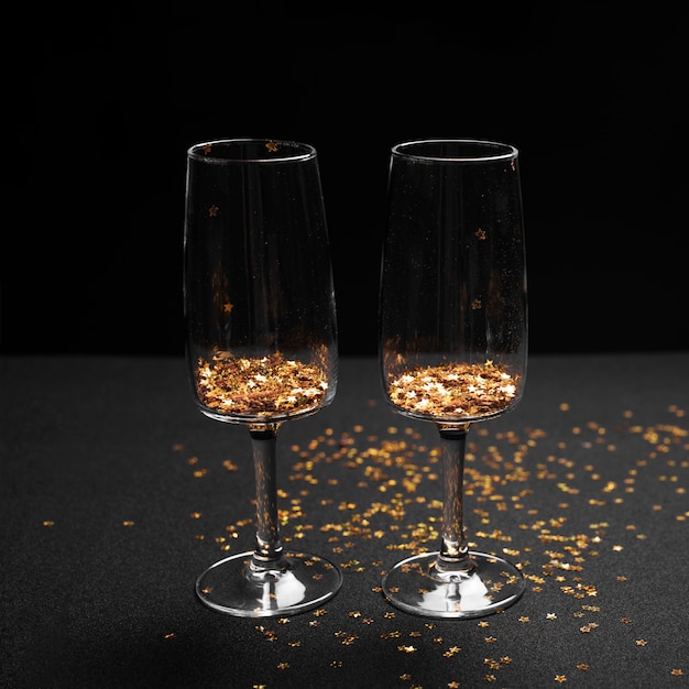 Glasses with bright spangles on table