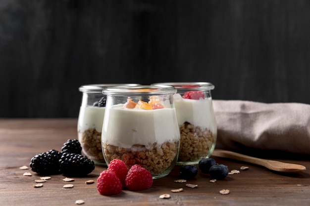 Free photo glasses with cereal and yougurt on desk