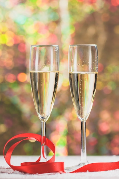 Glasses with champagne and a red bow