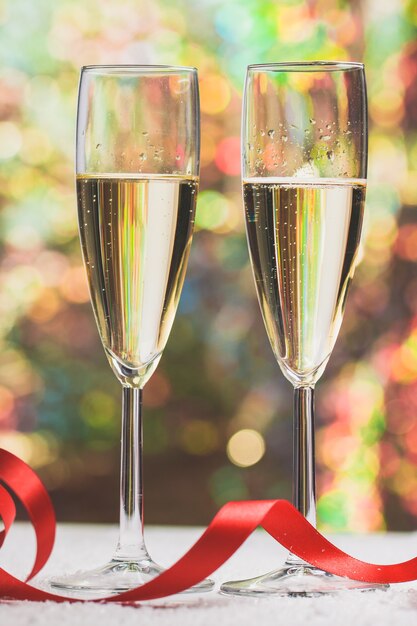 Glasses with champagne and a red bow