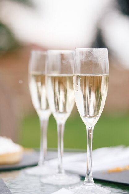 Glasses with champagne stand on the table