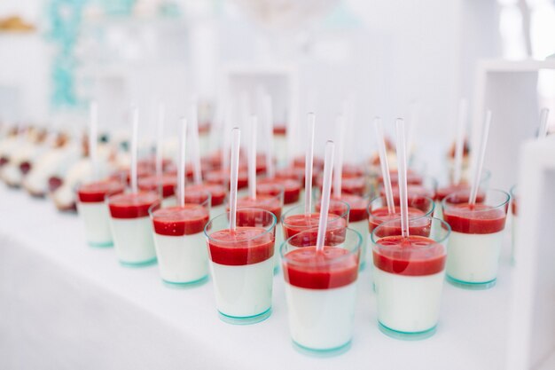 Glasses with cold desserts and strawberries