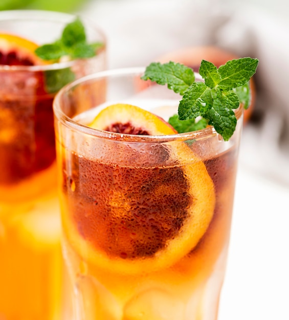 Glasses with fruit ice tea on desk