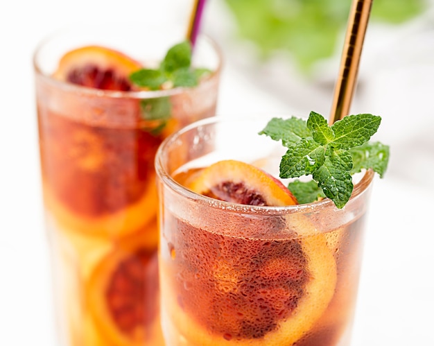 Glasses with fruit ice tea and mint