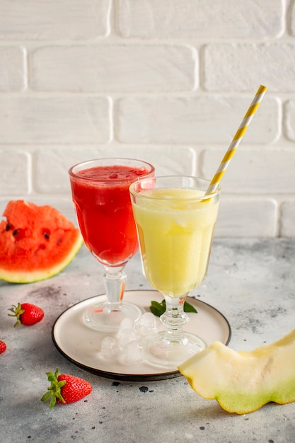 Glasses with red and yellow watermelon juice