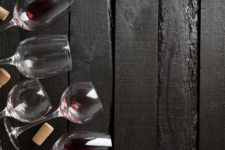 Free Photo glasses with wine and a corkscrew on a dark background