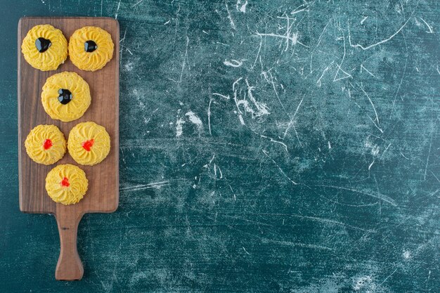 Glazed cookies on a cutting board , on the blue background. High quality photo