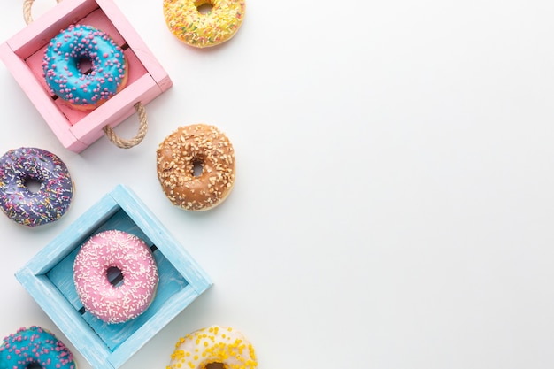 Free photo glazed donuts in boxes copy space