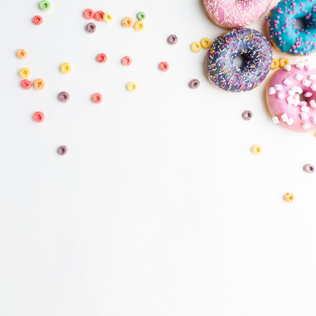 Glazed donuts with colorful cereals