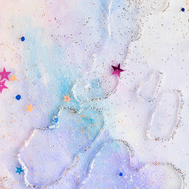 Glittery star confetti on colorful abstract pastel watercolor background