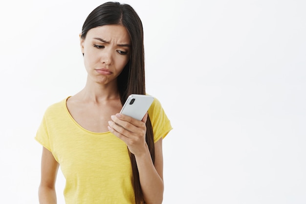 Gloomy girlfriend feeling sad boyfriend not picking up phone.